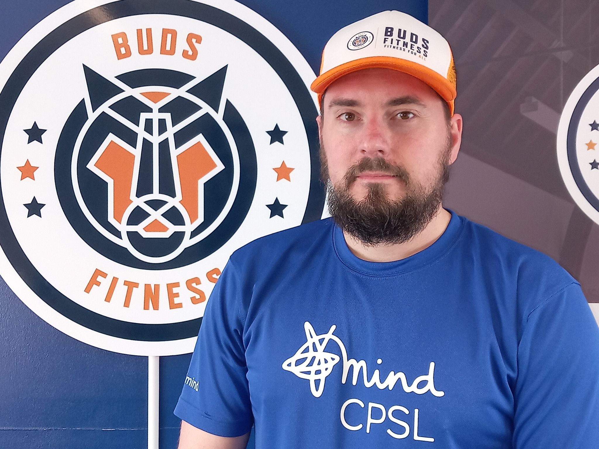 Liam Baker wearing Mind CPSL t-shirt in front of Buds Fitness logo