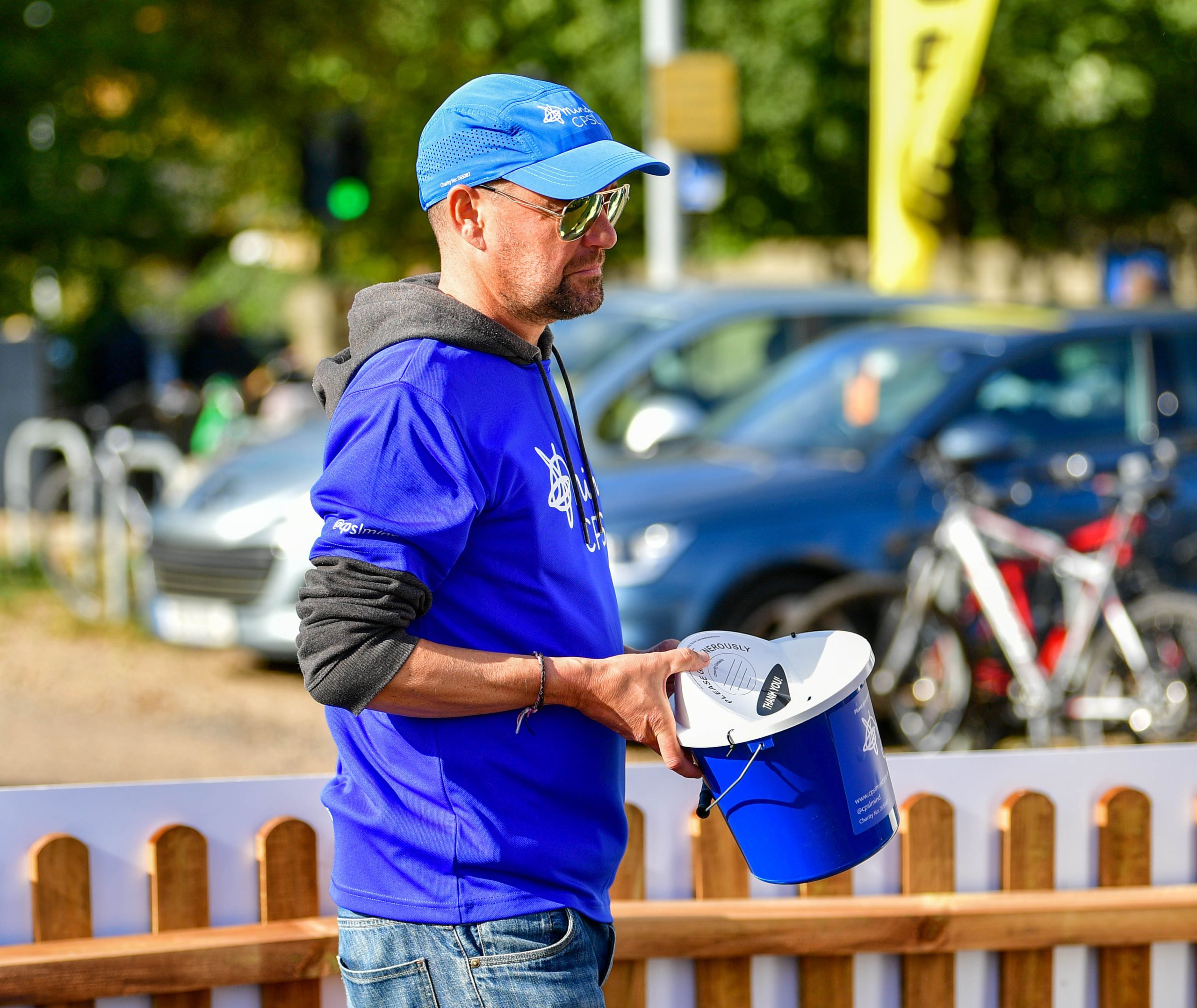 Member of CPSL Mind holding fundraising bucket