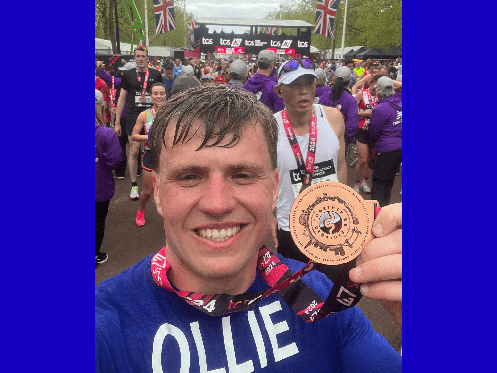 Man at running event holding medal