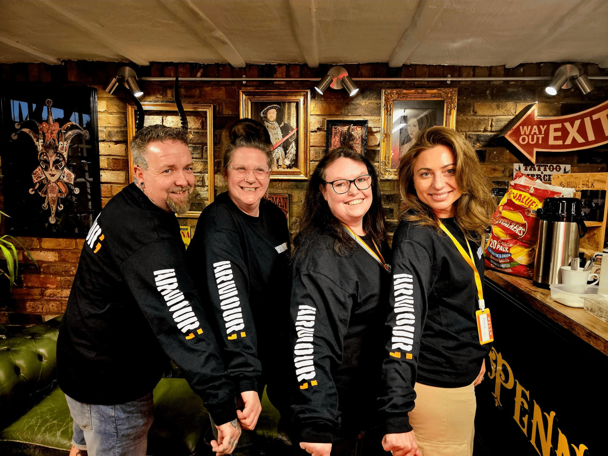 Men and women wearing hoodies with Armour Project branding