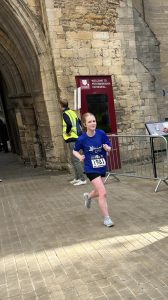 Girl running in blue t-shirt through catherdral