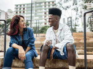 A man and woman talking to each other and laughing