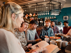 A group of people sitting at a cafe talking