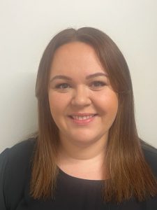 woman with brown hair smiling at camera